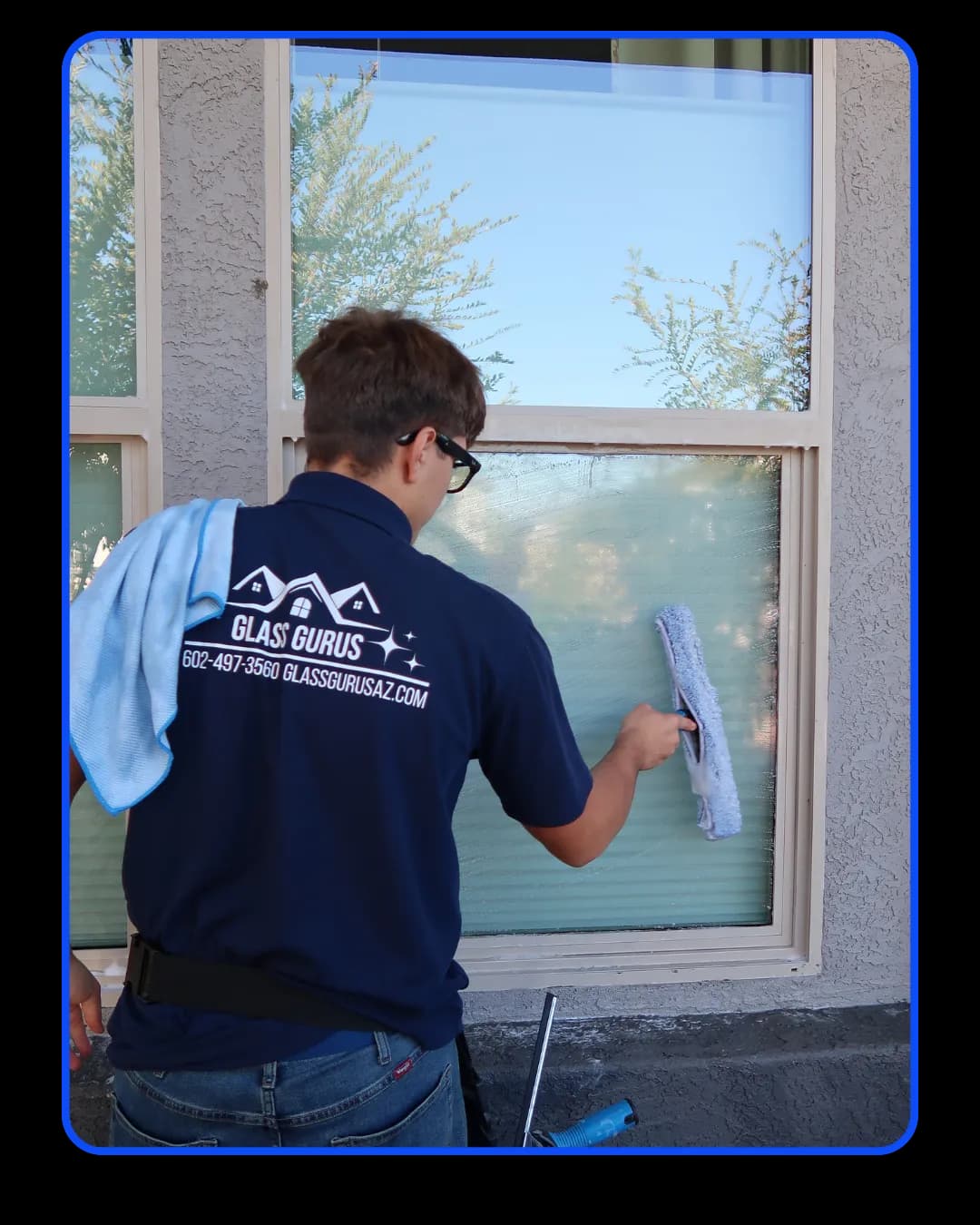 Glass Gurus technician cleaning a window to a streak-free shine in Gilbert, AZ